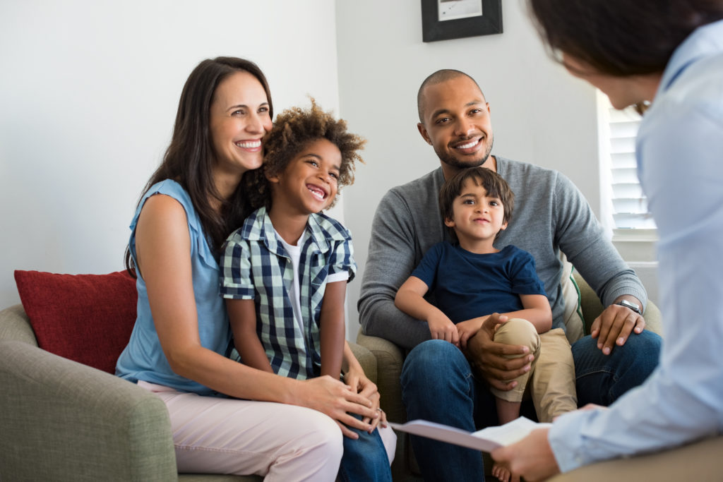 A happy family with children meeting with a counselor