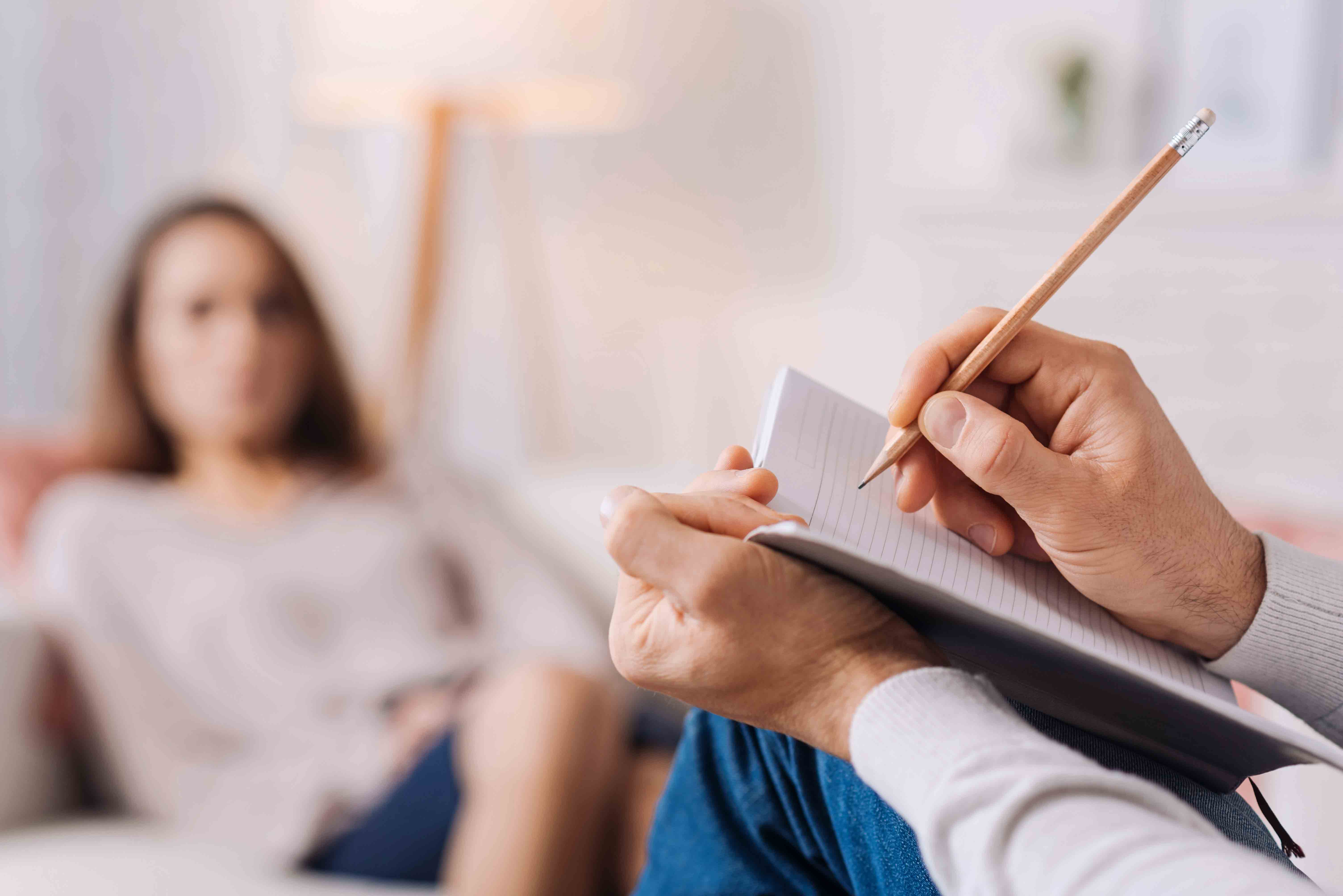 Therapist taking notes during an individual counseling session